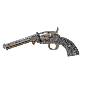 Detail view of vintage cowboy revolver replica with engraved patterns and silver finish