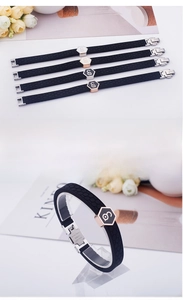 Detail of black silicone magnetic bracelets with rose gold and silver hexagonal metal accents
