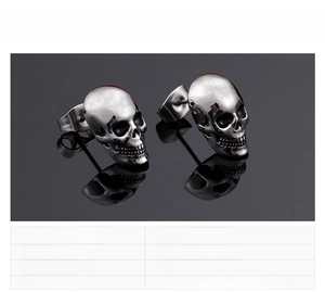 Detail view of gothic skull stud earrings for men in polished 316L stainless steel finish