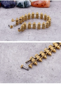 Detailed view of punk style gold bullet spikes and screw connectors on the steel bracelet