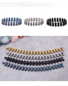 Detail view of punk rock spike bracelets in gold, silver, black, and rainbow steel