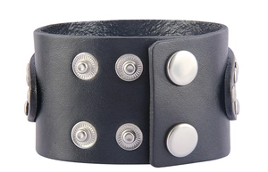 Close-up of black wide leather bracelet with silver metal snaps and decorative studs
