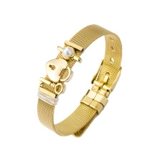 Detail of golden stainless steel mesh bracelet with heart lock and pearl charms