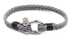 Macro view of grey braided leather bracelet with silver horseshoe metal clasp detail