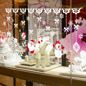 Christmas window decals with Santa, snowman and stockings on a jewelry store glass front