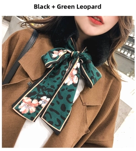 Detail of faux rabbit fur collar and green leopard floral silk scarf tied in a bow
