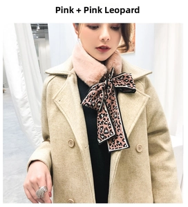Detail of pink faux rabbit fur collar with a leopard print silk ribbon bow accessory