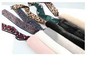 Detail view showing variety of faux rabbit fur winter scarves with leopard print silk ribbons