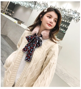 Detail of pink faux fur collar with leopard print bow on knit cardigan for women