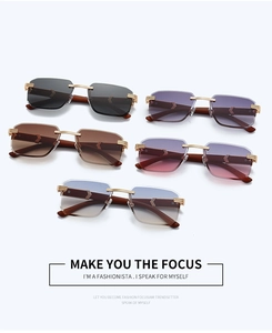Close-up of five rimless square sunglasses with wood texture temples and golden C-decor
