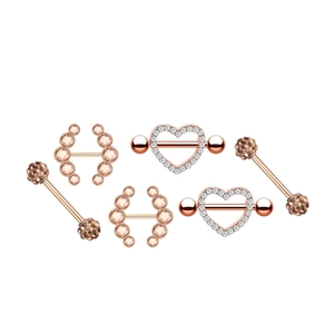Detail of six rose gold nipple rings with sparkling champagne and white zircons