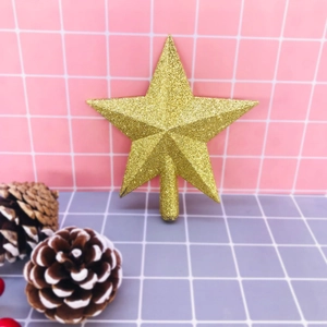 Sparkling gold star Christmas tree topper with glitter finish on a decorative background