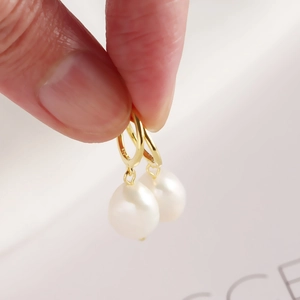 Close-up of S925 silver gold-plated hoop earrings with baroque freshwater pearl charms