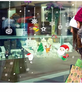 Close-up of Merry Christmas window decals with Santa, reindeer and snowflakes decorations