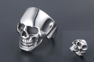 Macro shot of polished silver skull ring in punk gothic style with metallic reflection