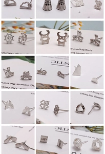 Macro shot of various silver-colored minimalist ear studs with diverse cute shapes