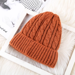 Winter mohair knit beanie in pumpkin orange with warm fleece lining and cable knit design