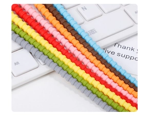 Close-up of various colorful spiral silicone cable ties for data cable management