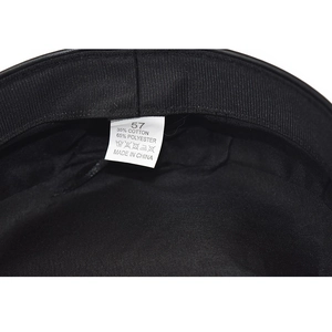 Close-up of the interior lining and size label for the black cotton-polyester newsboy hat