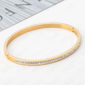 Detail of rose gold stainless steel bangle with 4mm single row crystal pavé setting
