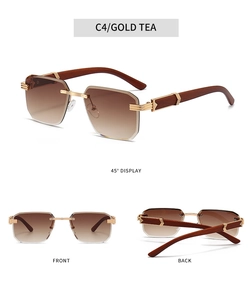 Detail view of gold tea gradient lenses with rimless geometric edge and wood texture temples