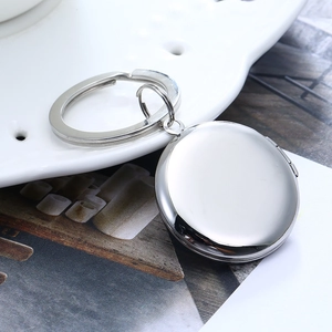 Portachiavi a medaglione rotondo in acciaio inossidabile lucido su piatto ceramico