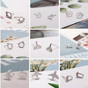 Macro display of diverse silver mini stud earrings featuring stars hearts and cute shapes