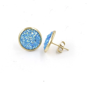 Macro detail of 12mm gold-plated stud earrings featuring sky blue druzy resin inlay