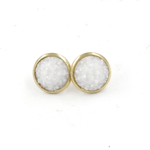 Detailed macro view of 12mm gold plated stud earrings with textured white druzy stones