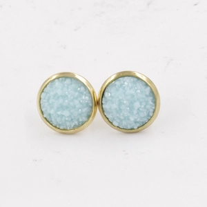 Detail of 12mm light blue druzy stud earrings with textured resin and gold plated base