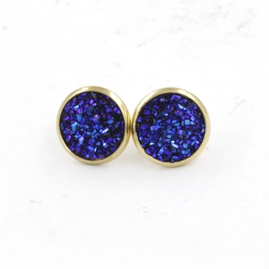 Macro detail of 12mm gold-plated stud earrings with blue-purple druzy stone texture
