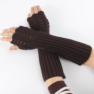 Detail of dark brown knitted fingerless arm warmers with fish scale texture and ribbed cuffs