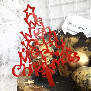 Red Merry Christmas acrylic cake topper in a festive tree shape with a star on top