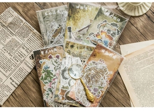 Detail of retro floral paper stickers on vintage wood desk with decorative magnifier