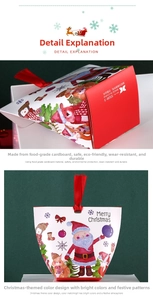 Detail of Christmas gift box featuring Santa claus prints and red satin ribbon handle