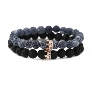Detail view of 2-piece beaded crown bracelets with matte black and gray cracked stones