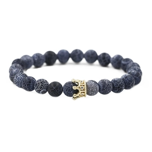 Detail of dragon vein agate beads and golden crown charm with inlaid zircons on bracelet