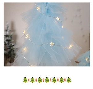 Detail of light blue mesh Christmas tree with warm white star LED fairy lights decoration