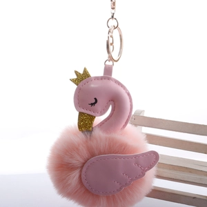 Detailed view of a pink swan pom pom keychain with glitter crown and golden keyring