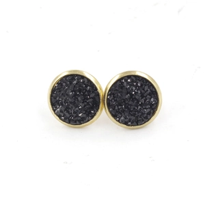 Macro shot of 12mm black druzy stud earrings with textured glitter finish and gold plating