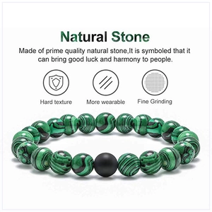 Detail of malachite beaded bracelet showing natural swirl textures and matte black stone