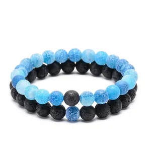 Detailed macro view of 8mm black lava stone and blue cracked agate beaded bracelets