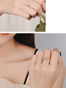 Detail of a cat-shaped silver ring with pink crystal on model's hand and finger