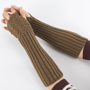 Close-up of brown knitted arm warmer showing thick ribbed texture and fingerless design