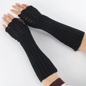 Detail of black knitted fingerless gloves with thumb hole and ribbed cuffs for warmth