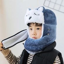 Detail of blue and white plush winter hat with cartoon animal ears and neck buckle