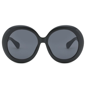 Retro oversized round sunglasses for women and men with thick black frames and dark grey lenses