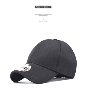 Detail of black textured baseball cap showing elastic fabric and size 58cm label