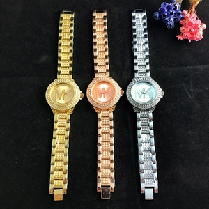Detailed view of three luxury diamond-set quartz watches in gold, rose gold and silver finish