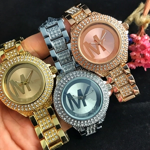 Fashion quartz watch set in gold silver and rose gold with double row crystal bezel and MK logo
